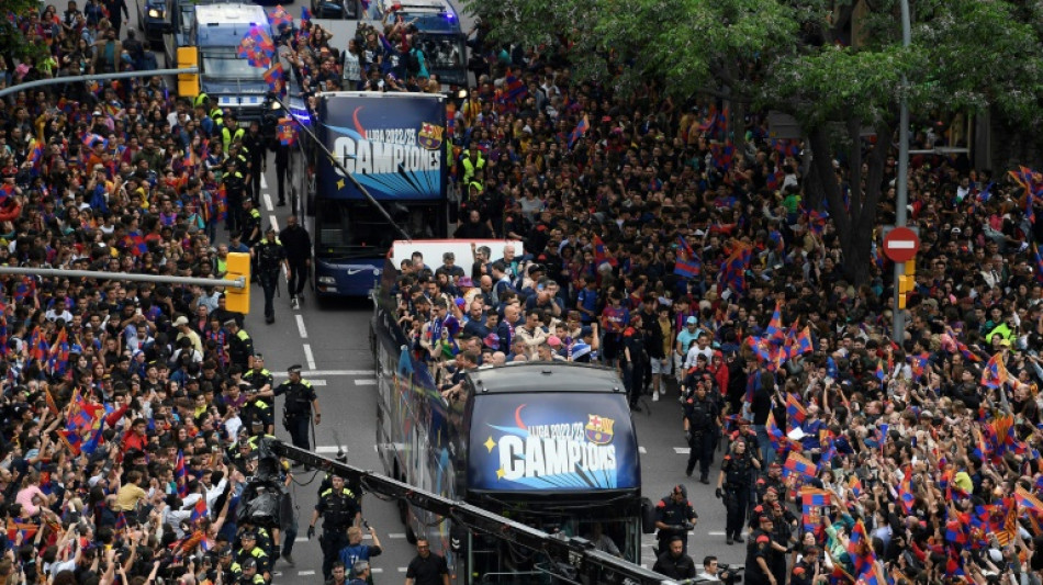 Barca fans celebrate league titles with players in parade